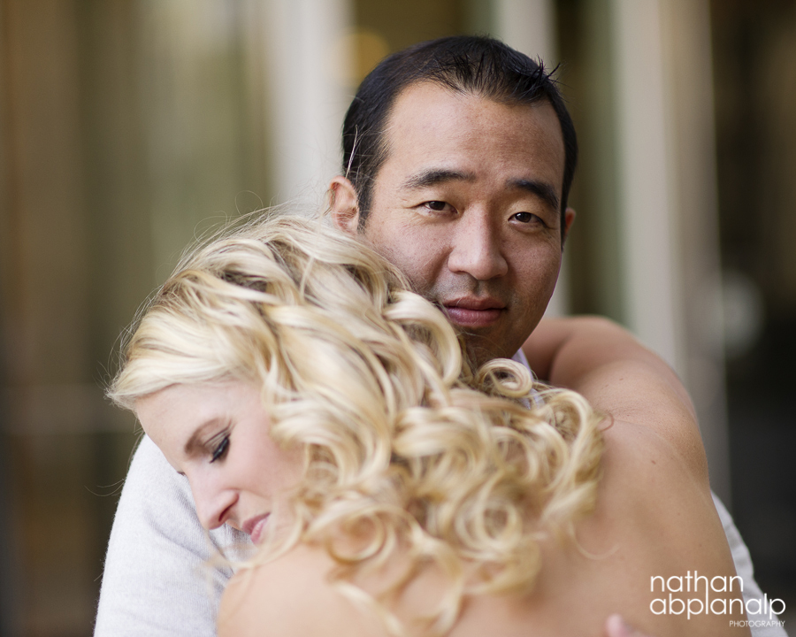 Interracial couple embracing during an uptown engagement shoot in charlotte nc