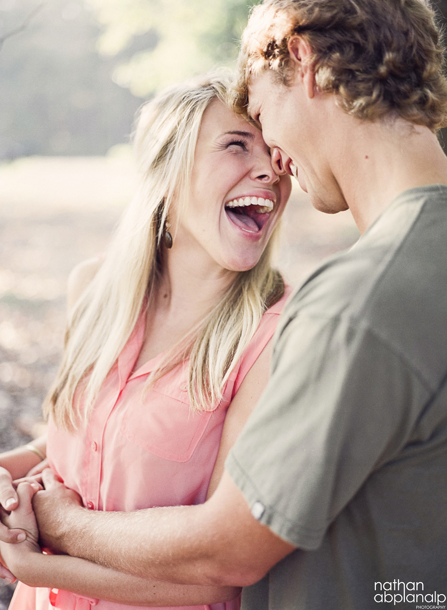 Couple smiling at each other in uptown charlotte nc