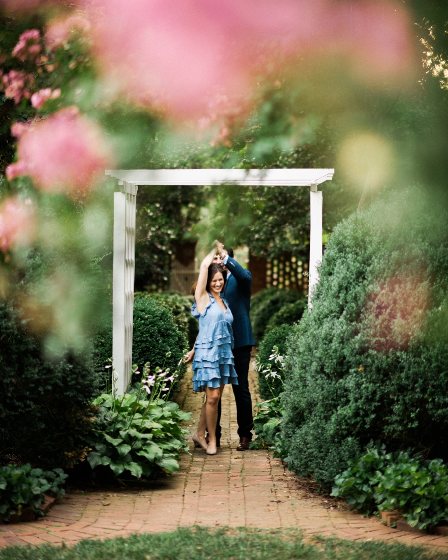 Couple embracing at Wing Haven Gardens in Charlotte, NC