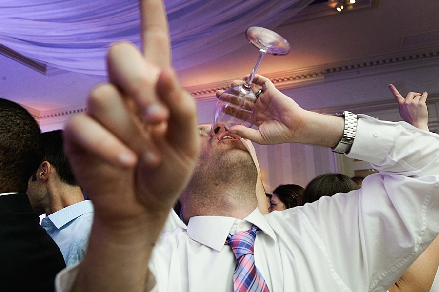 Wedding guest drinking champagne at the Carmel Country Club in Charlotte NC