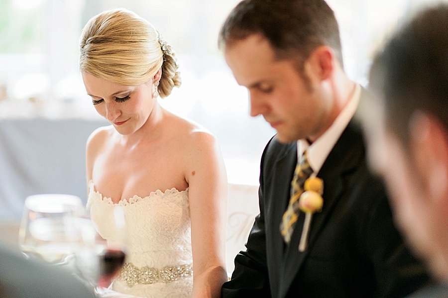 Bride and groom bow their heads during the blessing at Foundation for the Carolinas in Charlotte NC