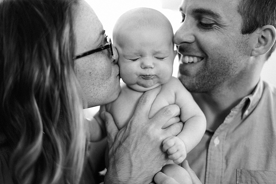 Mother and Father kiss their baby's cheeks in Charlotte NC