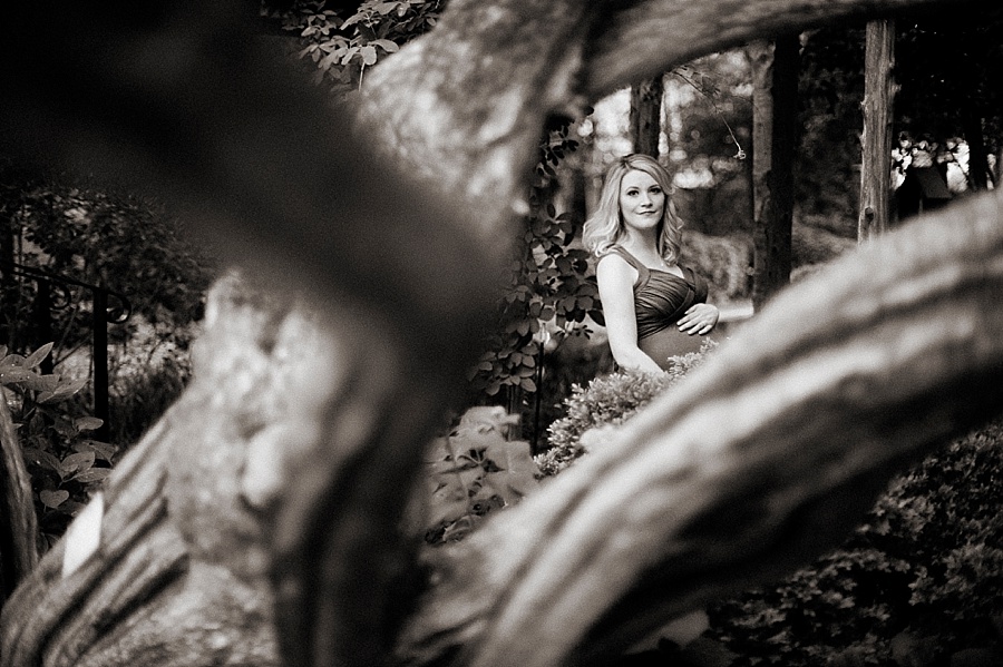 Mother poses for Maternity Session at Wing Haven Gardens in Charlotte