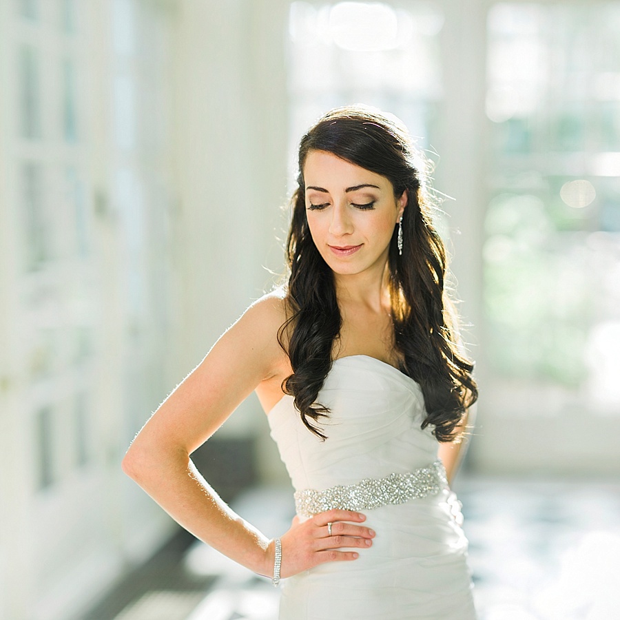 Bride with hands on hips at the Duke Mansion in Charlotte NC
