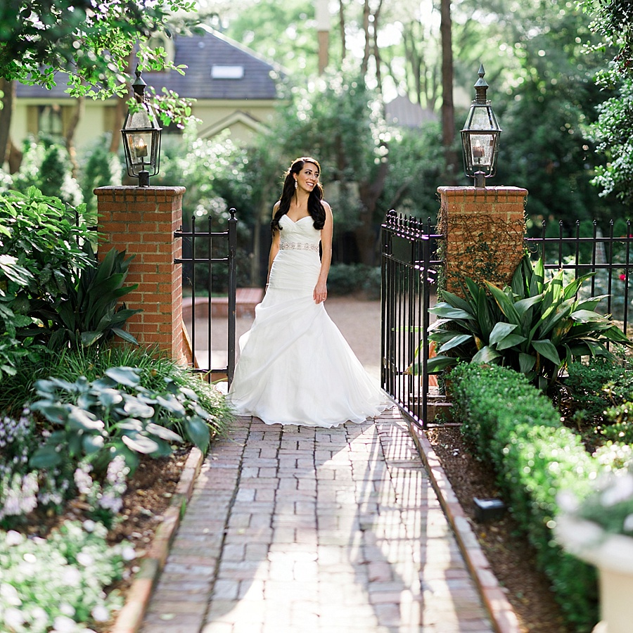 Bride posing on walk way of the Duke Mansion in Charlotte NC