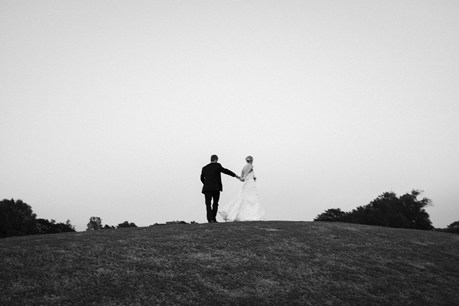 B&W couple walking on the green at the Carmel Country Club in Charlotte NC