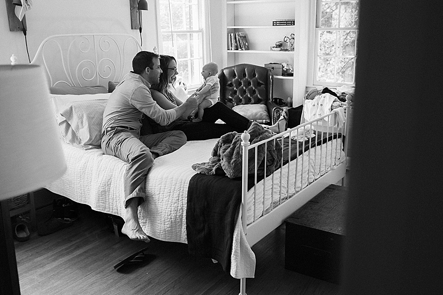 Mother and Father with baby on bed in Charlotte NC