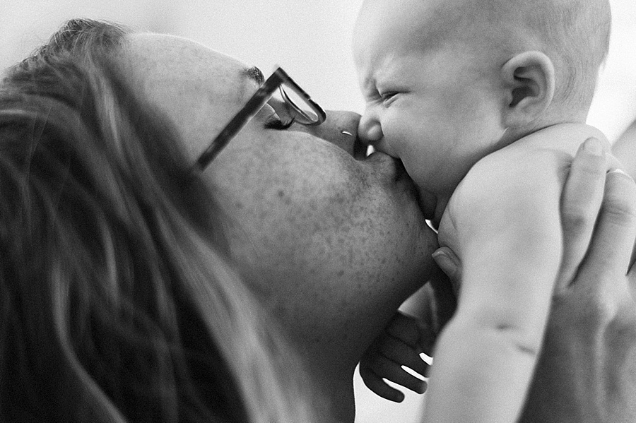 Mother kissing newborn baby in Charlotte NC