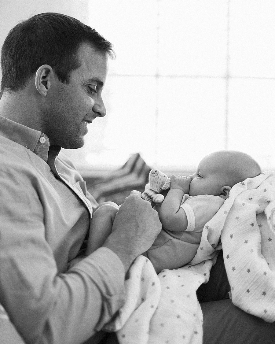 Father looking at newborn baby in Charlotte NC