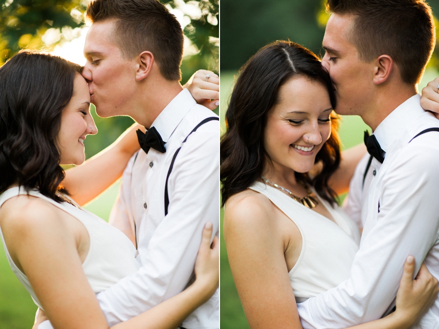 Man kissing woman's forehead in a park in Charlotte NC