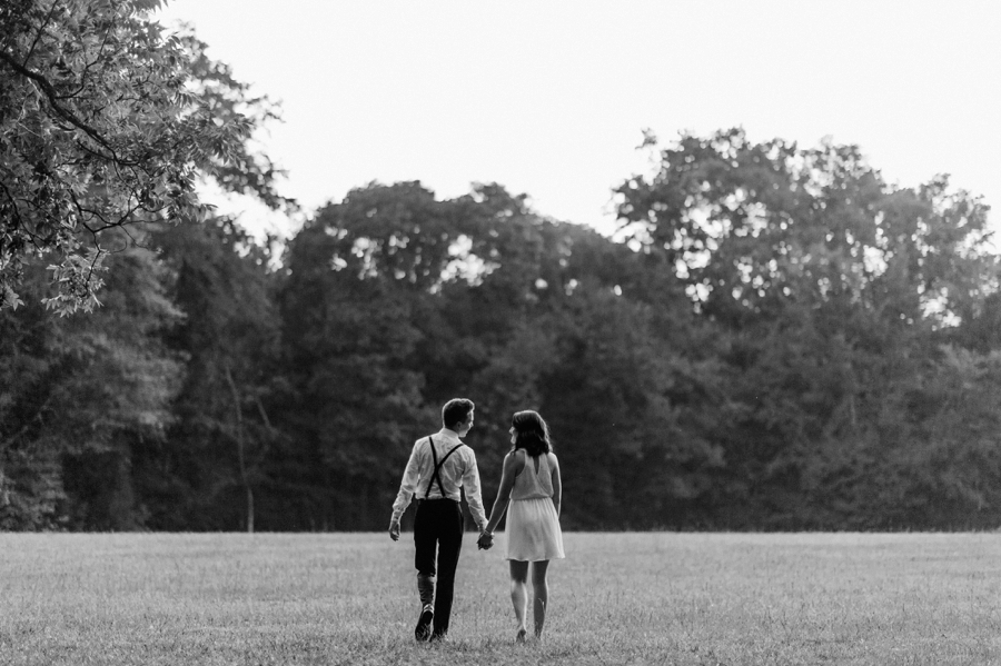 Couple walking in field in Charlotte NC