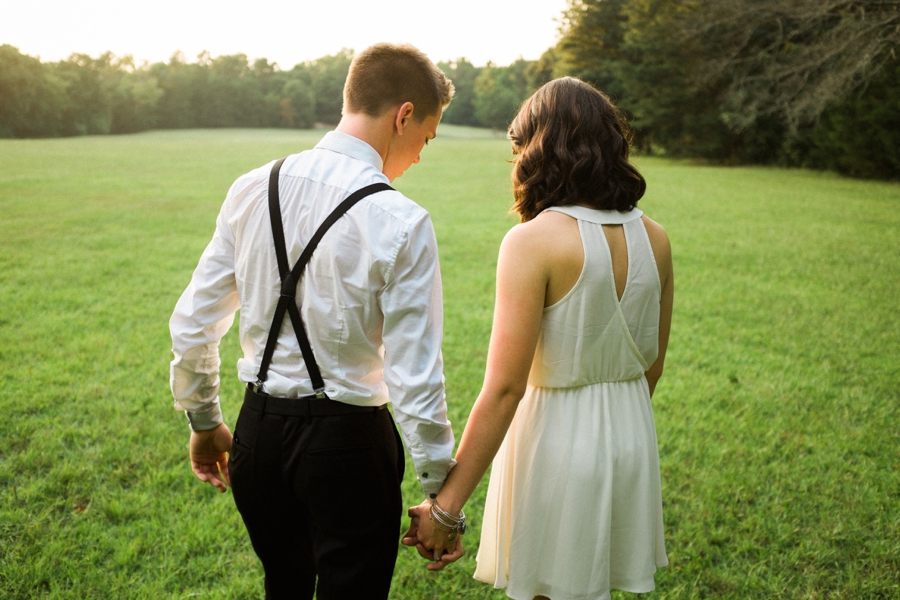 Groom leading bride in field in Charlotte NC