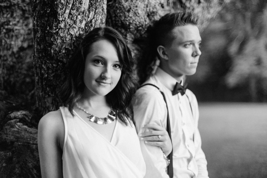 Couple leaning against tree during an engagement session in Charlotte NC