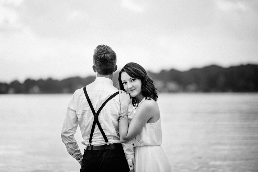 Woman leaning on man's shoulder on the shores of Lake Wylie in Charlotte NC