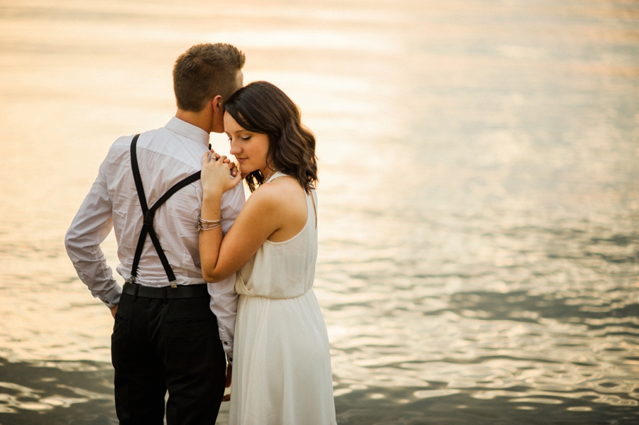 Woman leaning on man's shoulder on the shores of Lake Wylie in Charlotte NC