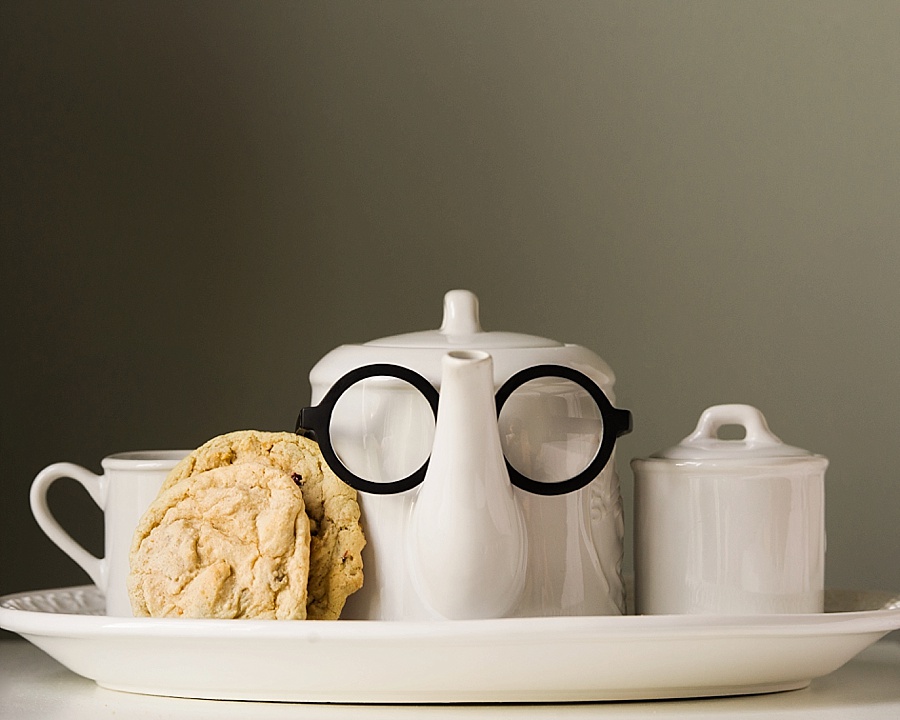 A teapot with glasses on with  cookie and a sugar bowl for the Cookie Cult in Charlotte NC