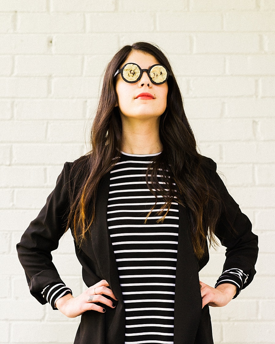 Girl standing with hands on hips with glasses on filled with cookies for The Cookie Cult in Charlotte NC