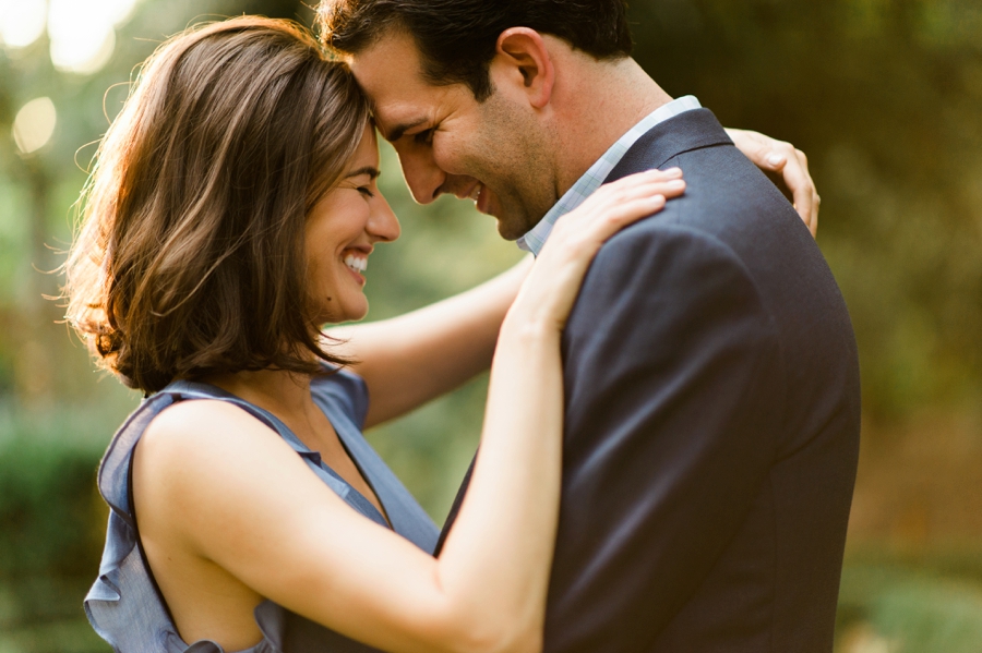 Couple touching foreheads during an engagement session at Wing Haven Gardens in Charlotte NC