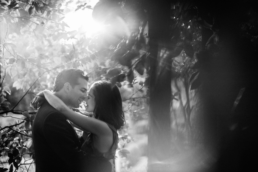 B&W of couple kissing at Wing Haven Garden in Charlotte NC