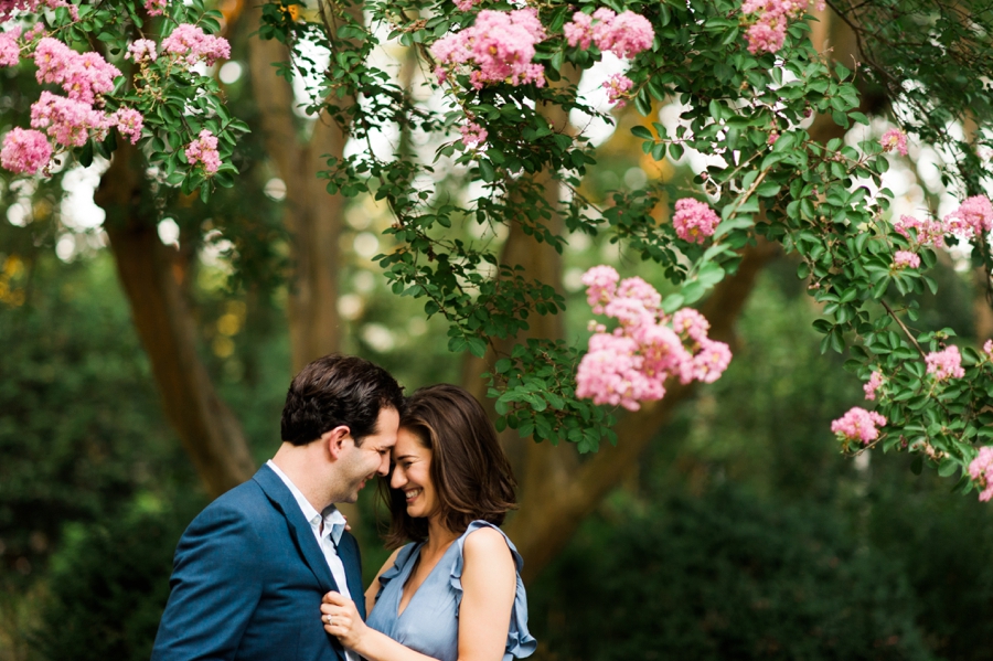 Couple touching foreheads at Wing Haven Garden in Charlotte NC