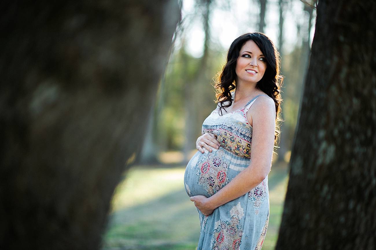 woman looks off camera during her maternity shoot at Westminster Park, Rock Hill, SC