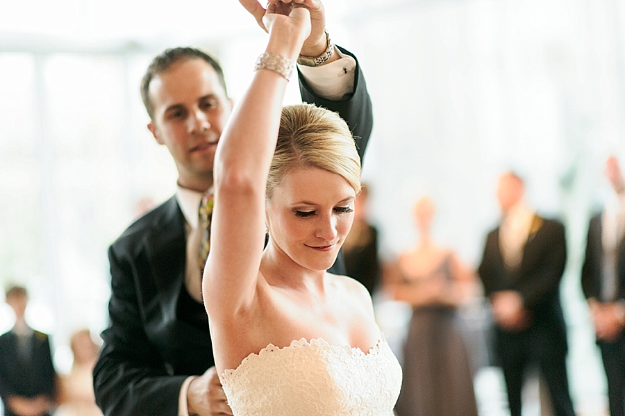 Groom twirls bride during first dance at Foundation for the Carolinas in Charlotte NC
