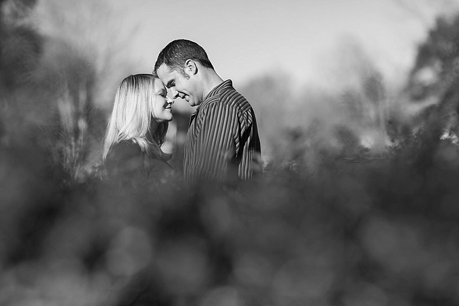 Husband and wife touch foreheads at Independence Park in Charlotte NC