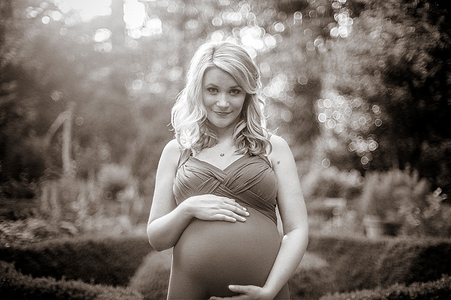 Pregnant mother poses for maternity photos at Wing Haven Gardens in Charlotte NC