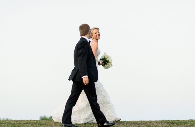 Bride and Groom walking on the green at the Carmel Country Club in Charlotte NC