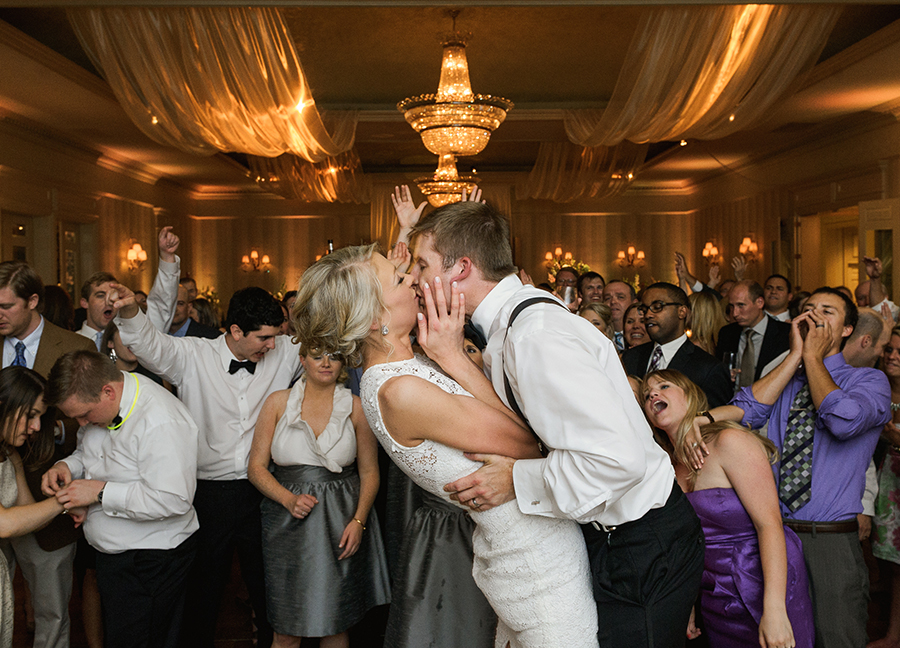Groom kissing bride while dancing at the Carmel Country Club in Charlotte NC