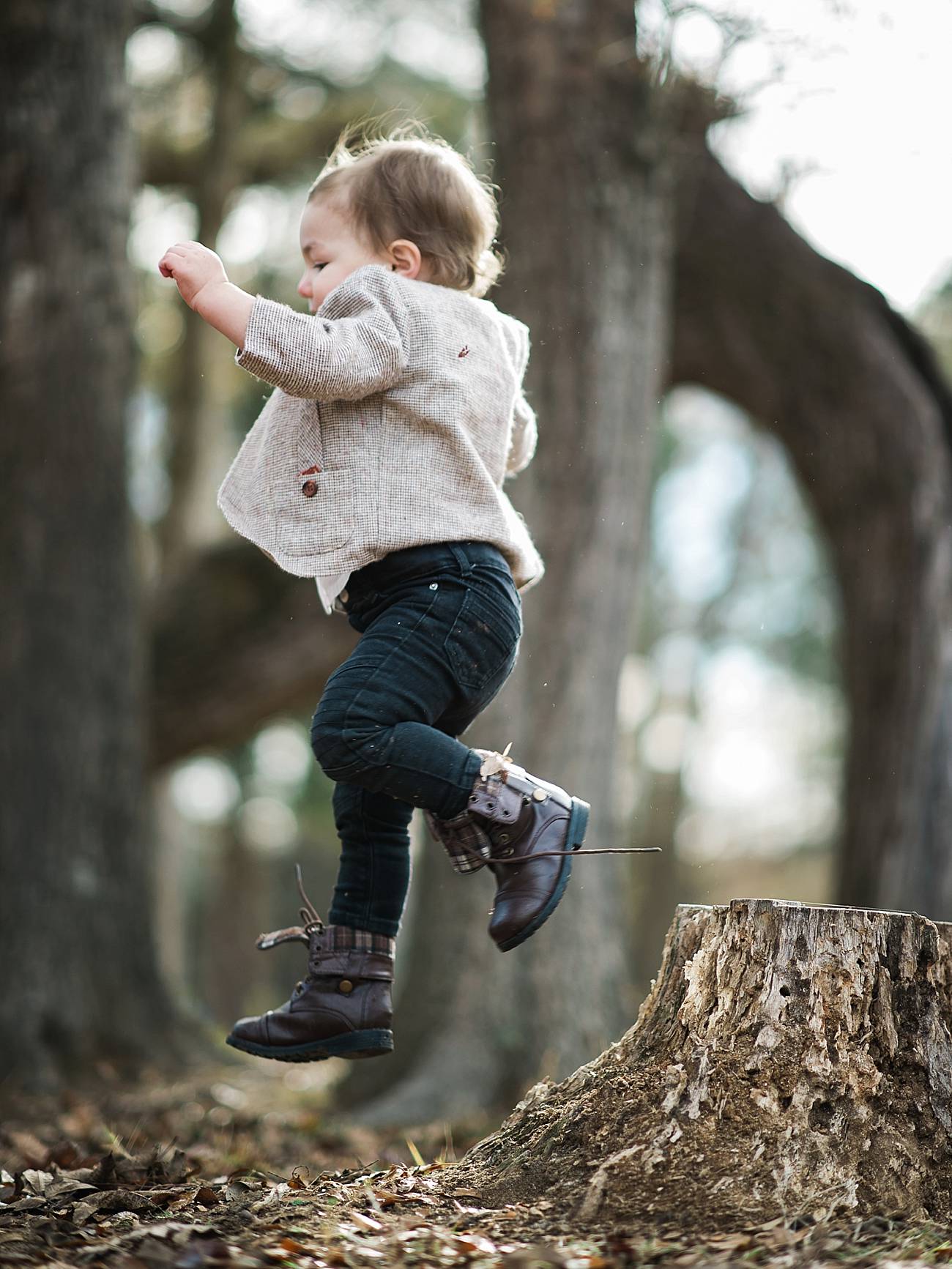 Little boy jumps off a stump at Westminster Park, Rock Hill, SC