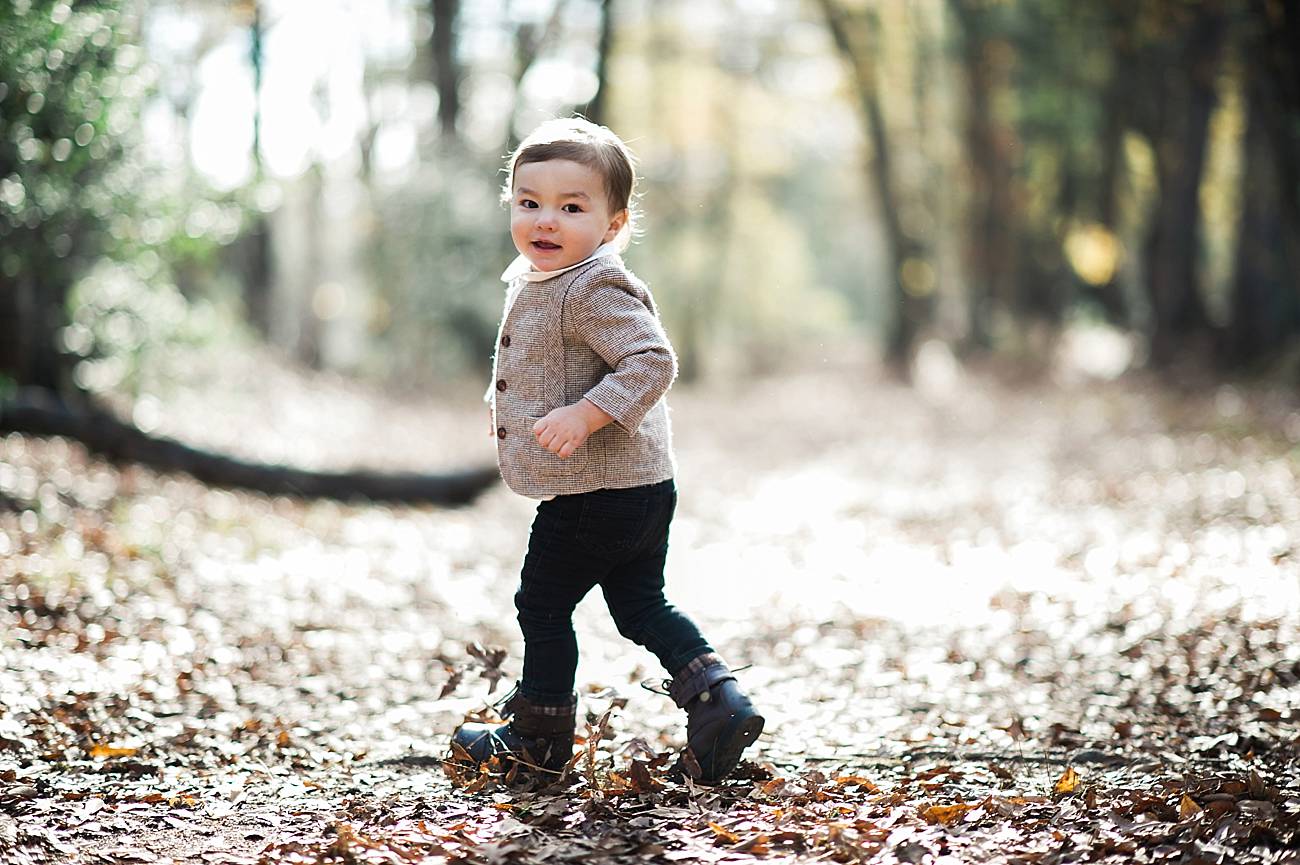 Little boy runs through the woods at Westminster Park, Rock Hill, SC
